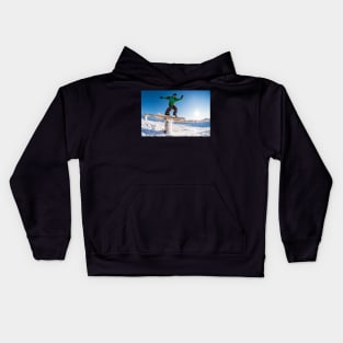 Snowboarder sliding on a rail Kids Hoodie